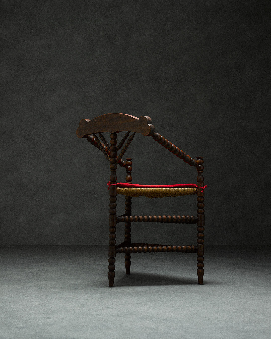 triangular bobbin chair — side profile with dark wood and woven seat