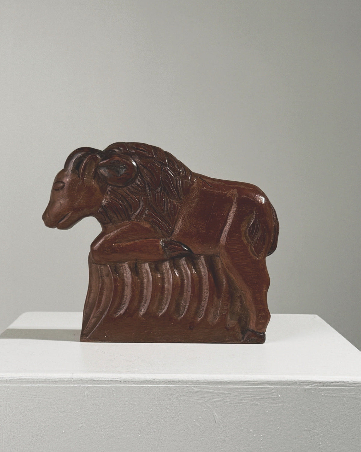 Carved wood ram sculpture in reclining position, late 19th century