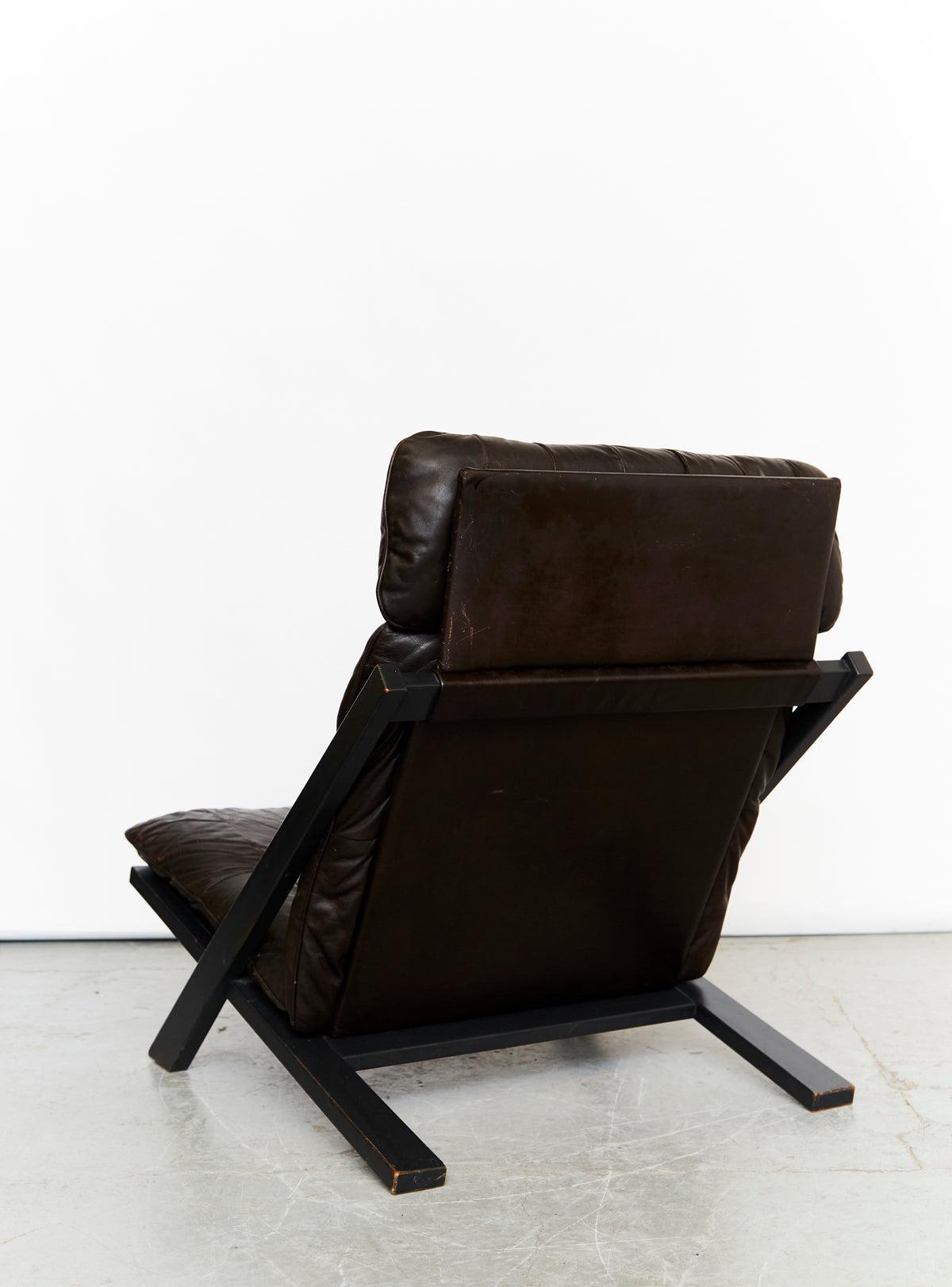 Rear view DS80 brown leather lounge chair with dark wood frame
