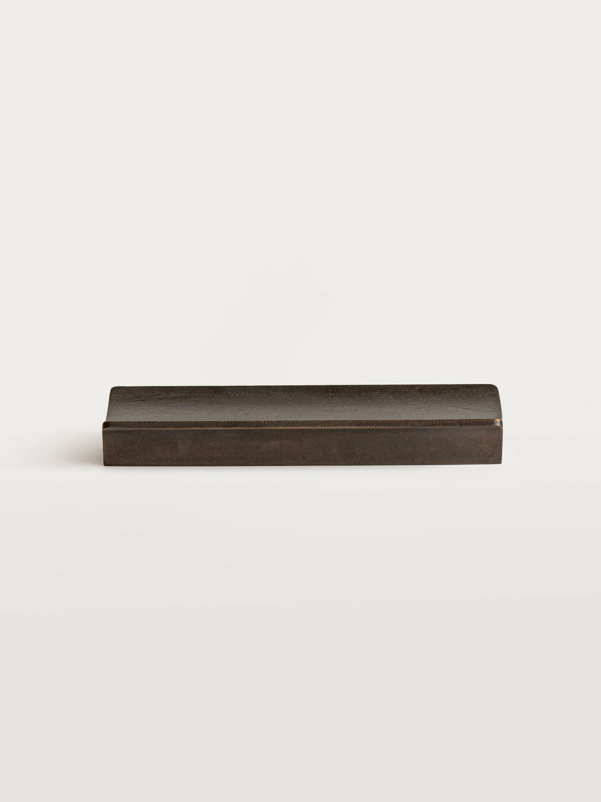 Arc Pen Tray — top view of dark metal design on white background