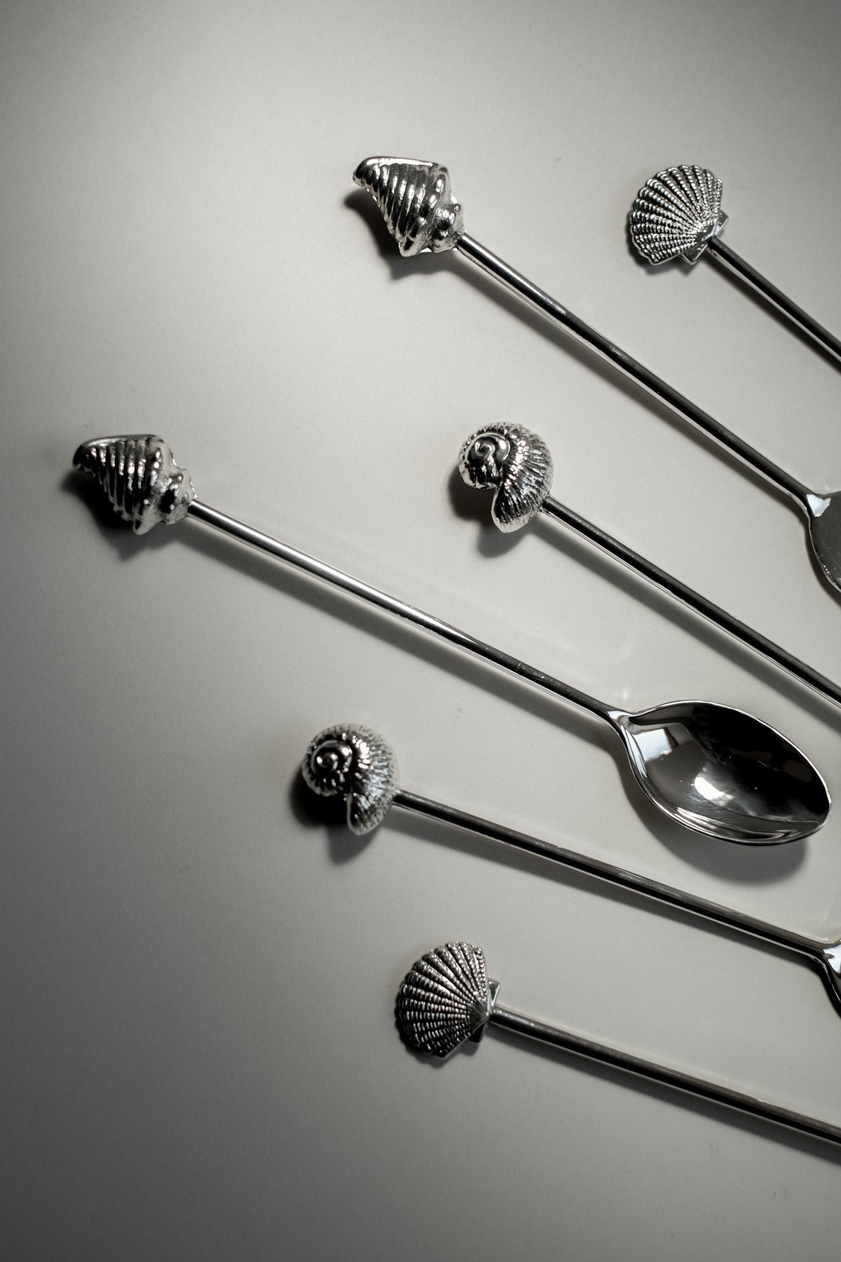Silver-Plated Seashell Cutlery Set — top view of cutlery on gray surface