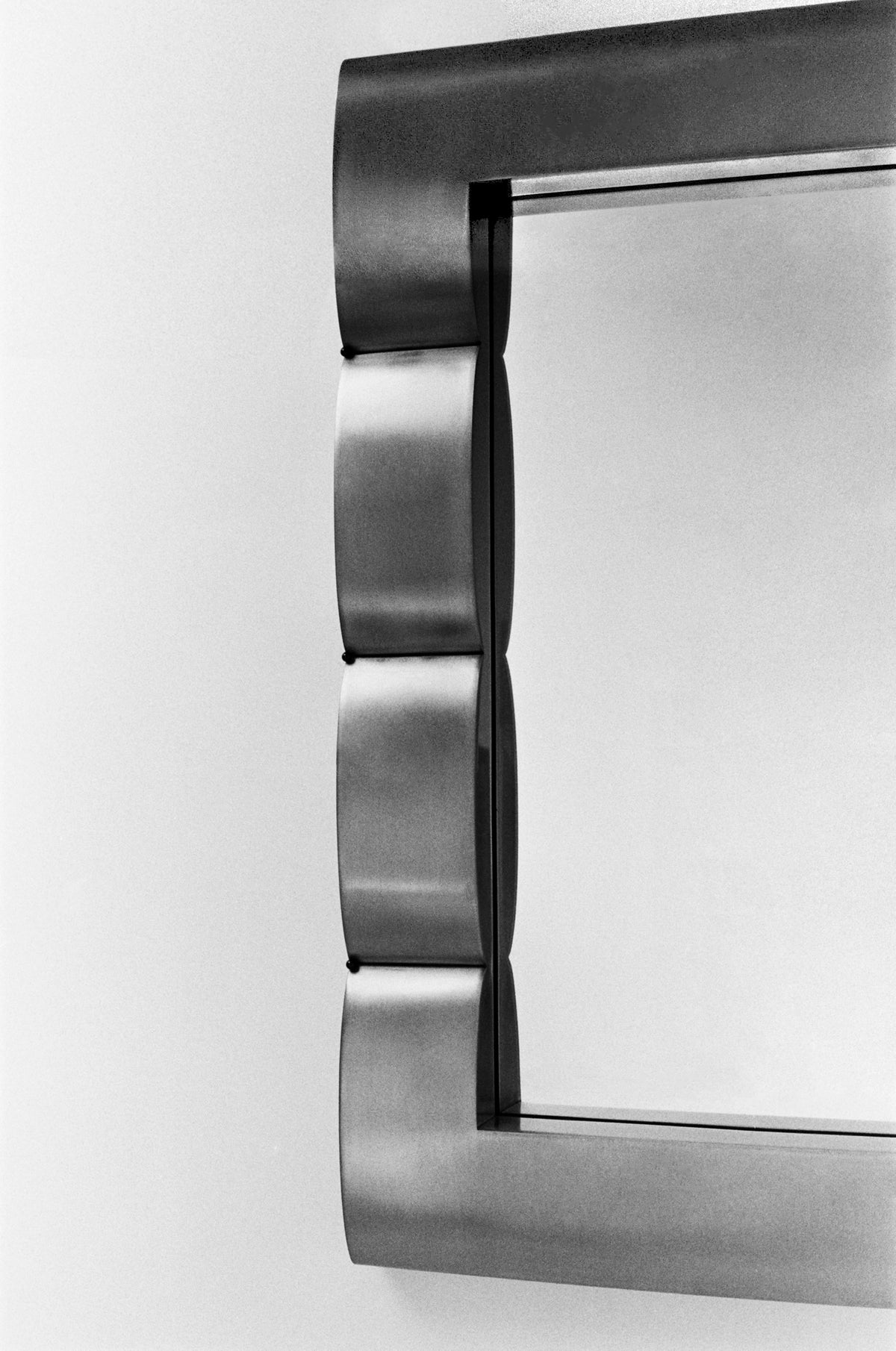 Mirror "Fluted Chambre", Contemporary Mirror in Steel — side angle showing curved steel frame