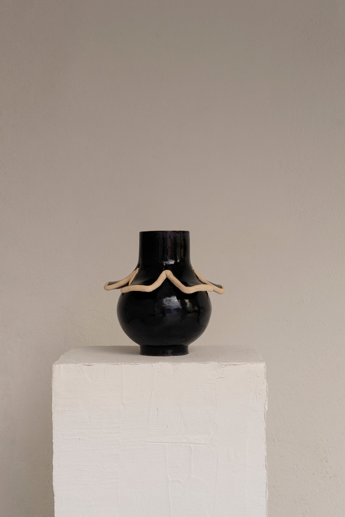 Navy blue ceramic vase with cream wavy clay relief detail