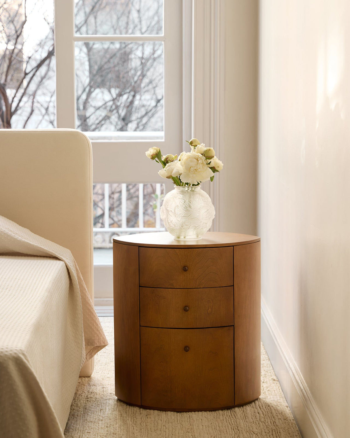Observer nightstand warm brown birch with vase in bedroom setting