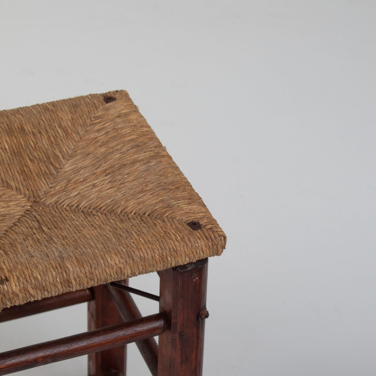Pair of Rustic Wooden Stools with Woven Rush Seats — close-up of woven rush seat