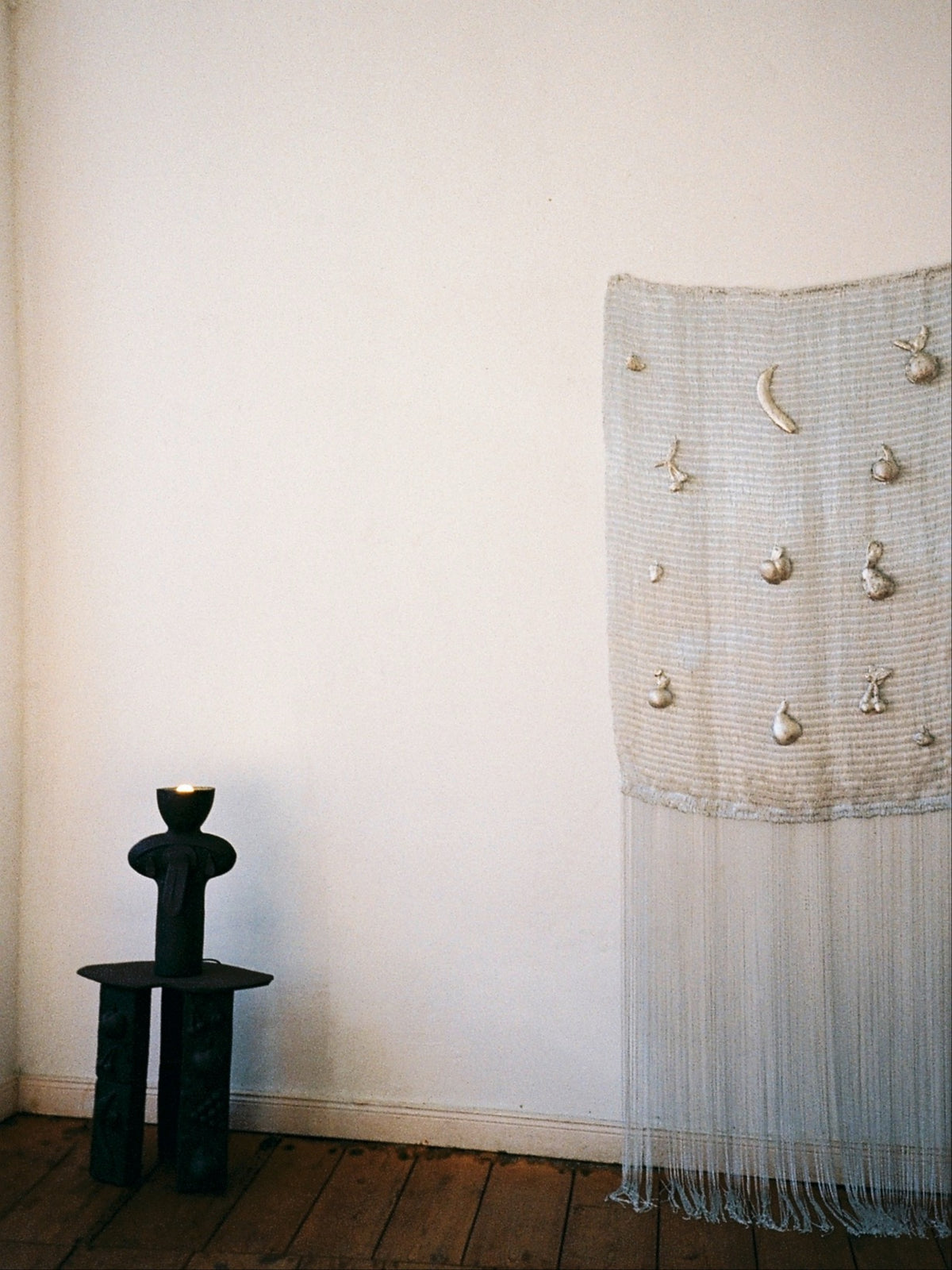 Textile wall sculpture with fruit motifs and fringe detail