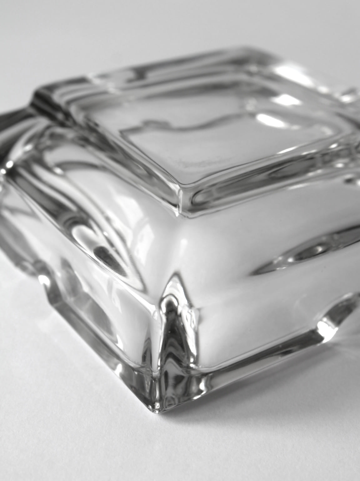 Clear crystal glass ashtray with geometric ridged design detail