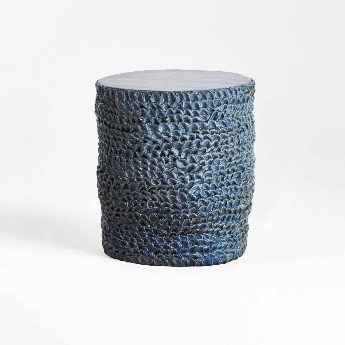 Casa Ceramic Side Table — textured blue ceramic surface in studio setting