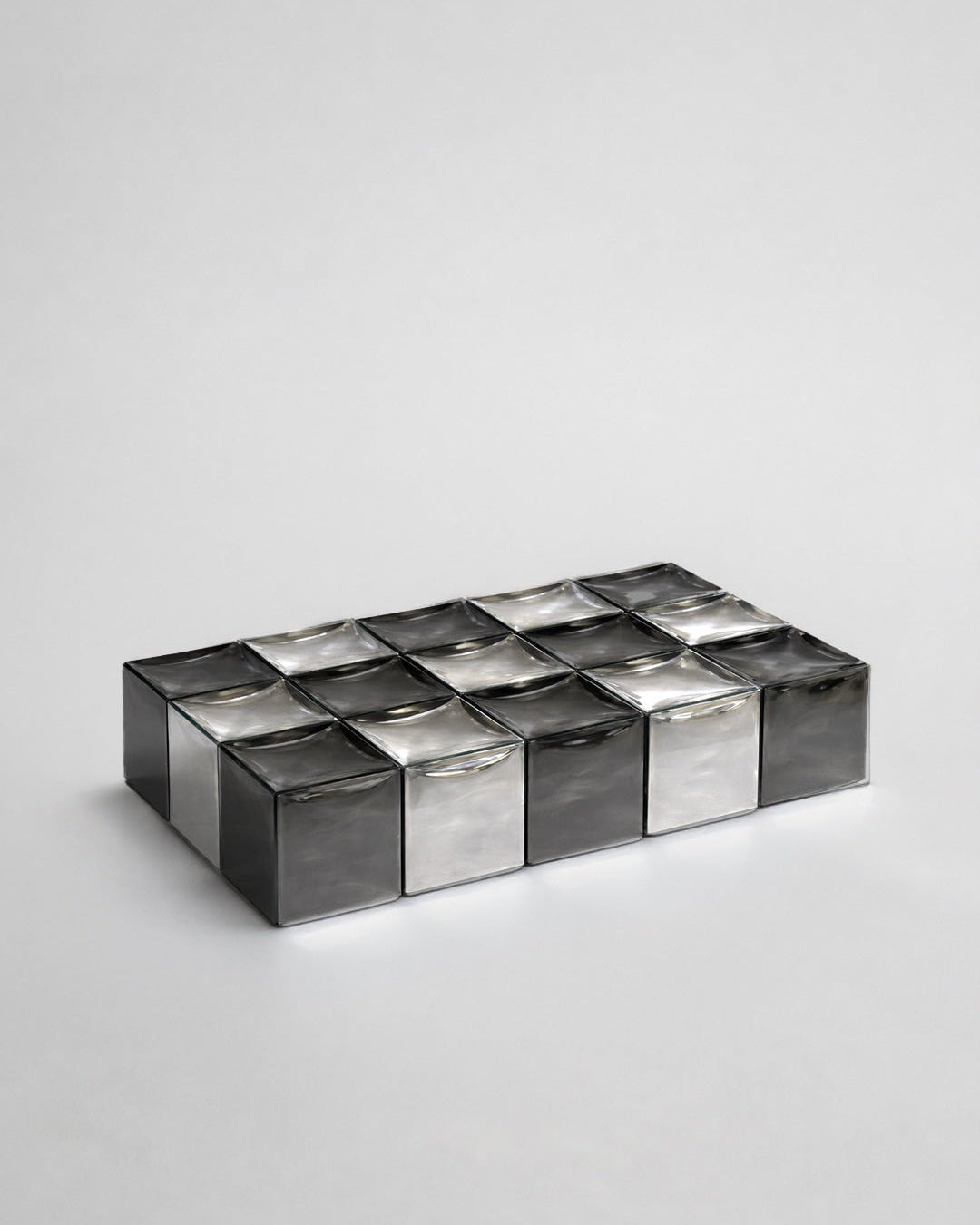 MONOLIT' Coffee Table — side angle showing reflective metal surface
