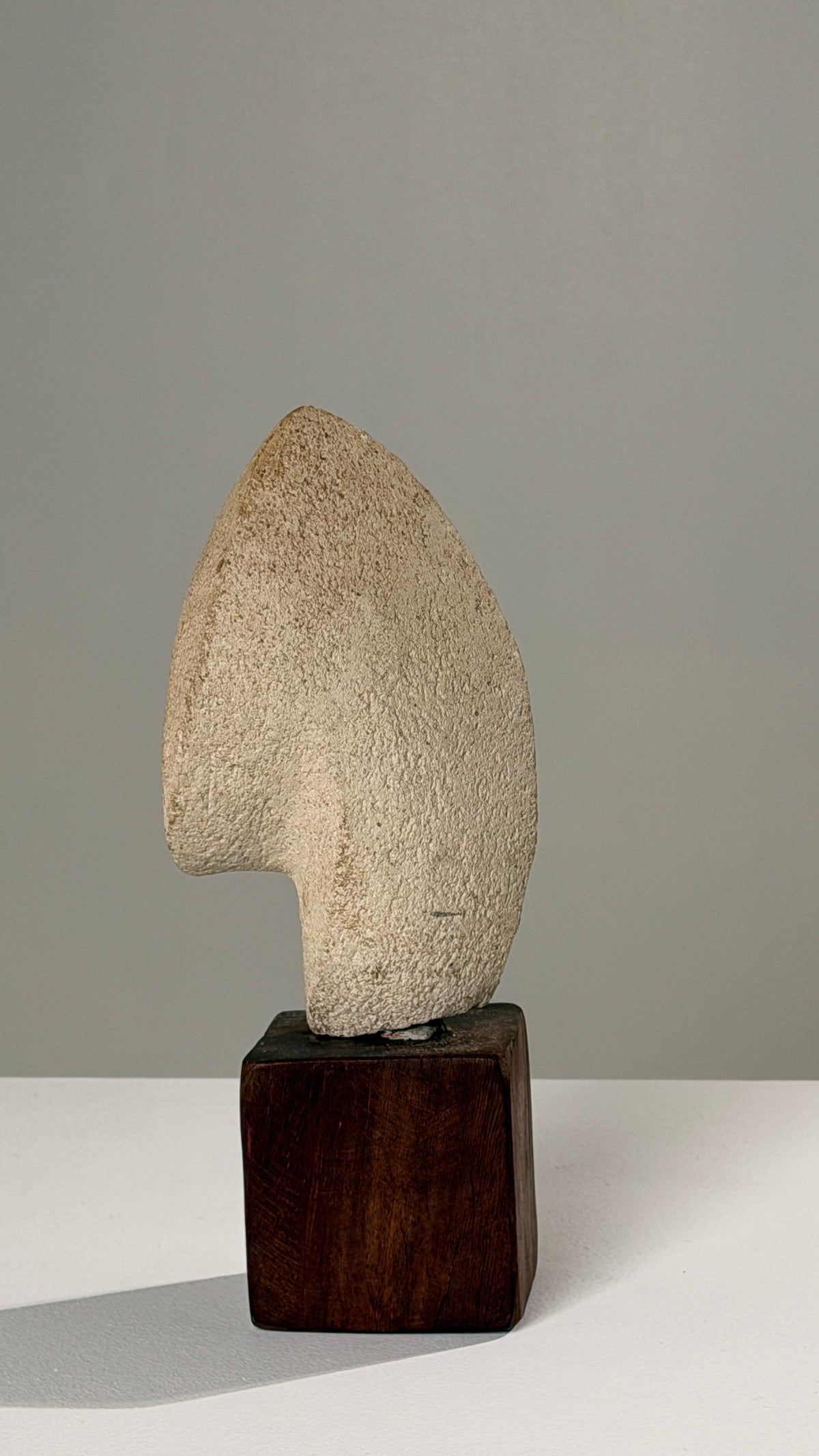 Stone Sculpture on Base, Anonymous Artist, France, circa 1950 — side angle showing textured stone on wooden base