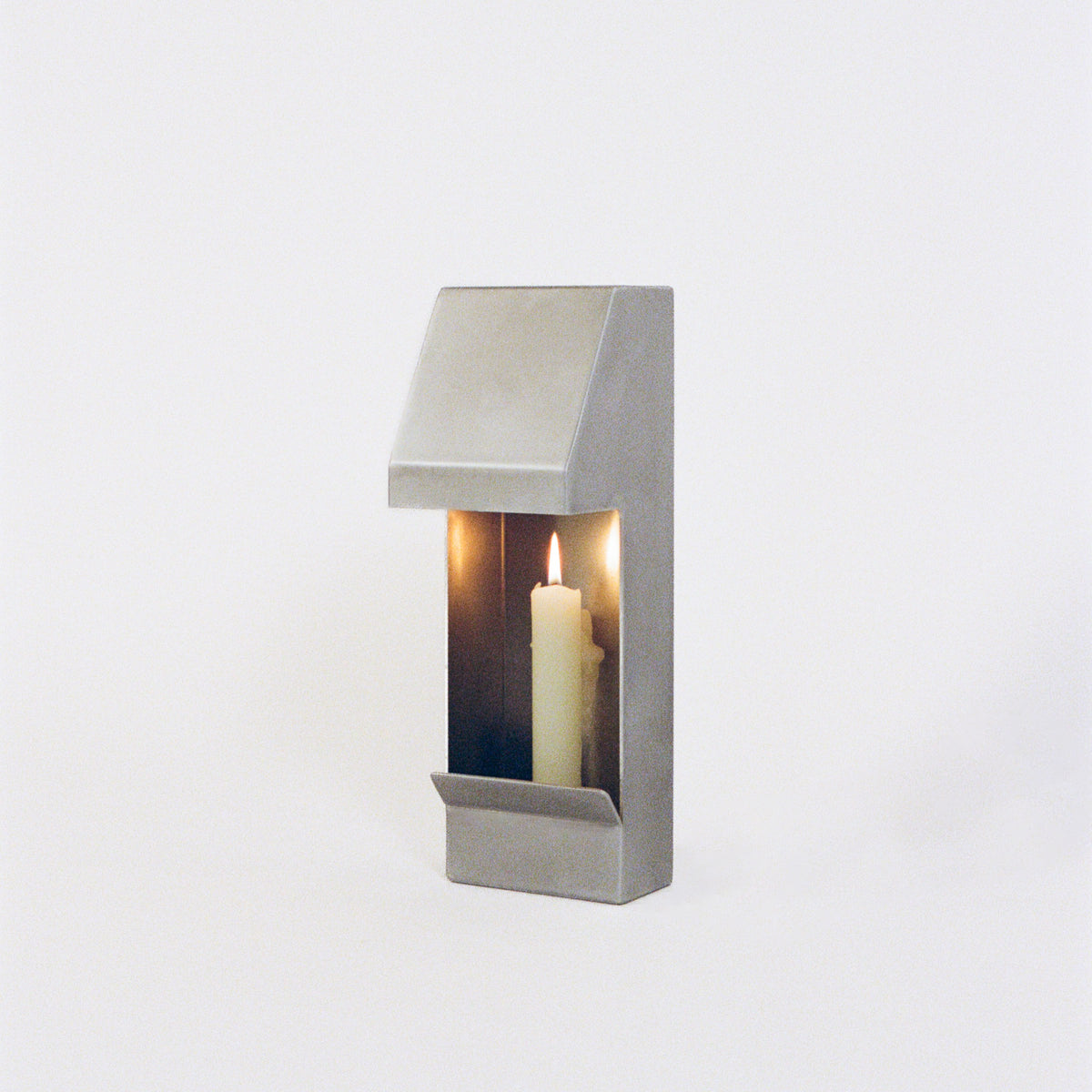Egress Sconce Candle Holder — angled view of brushed metal finish