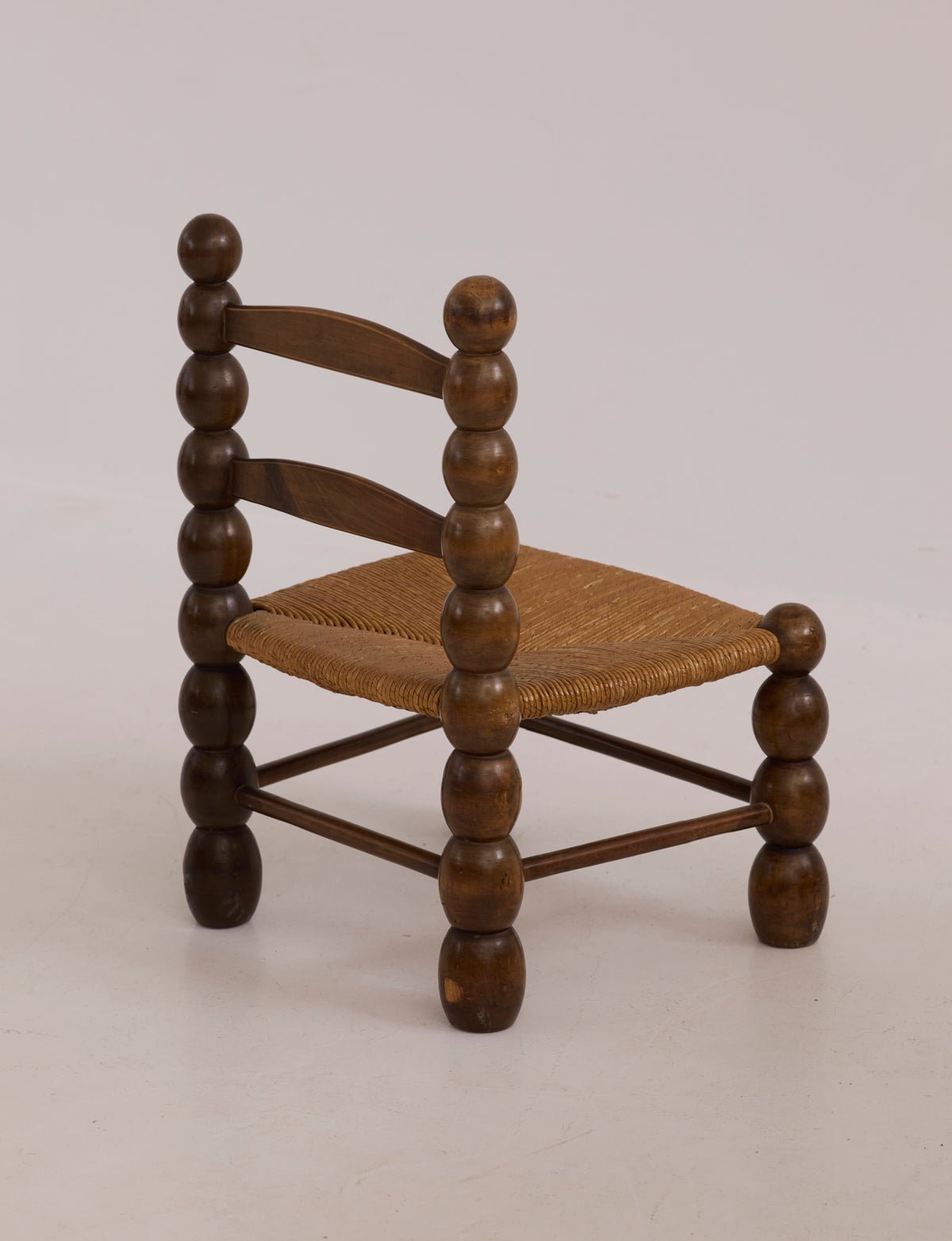 Vintage French Oak Wood and Straw Low Chair C. 1940 — side view highlighting round wooden legs