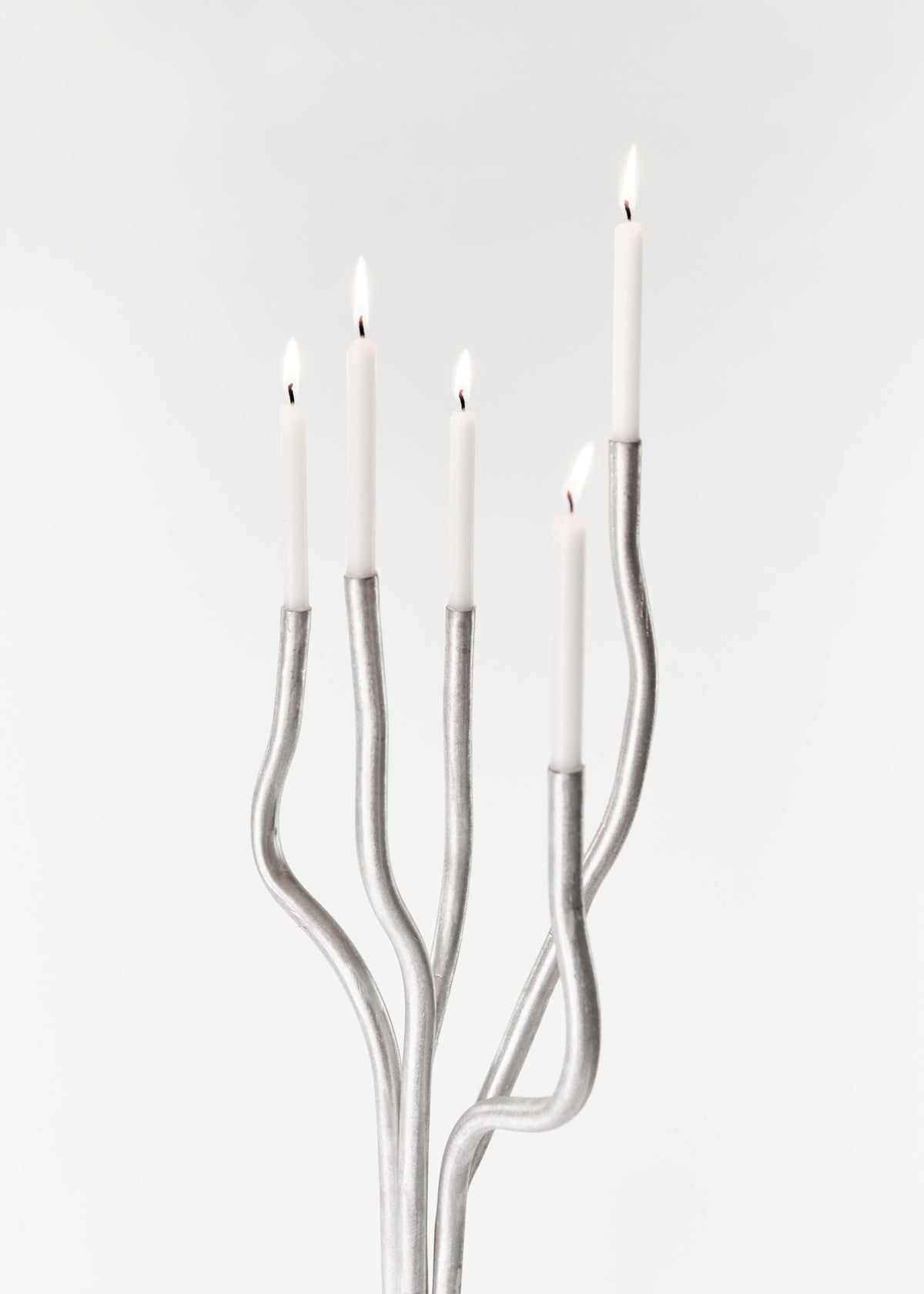 Tall Aluminum Candelabra — five candle holders with lit candles