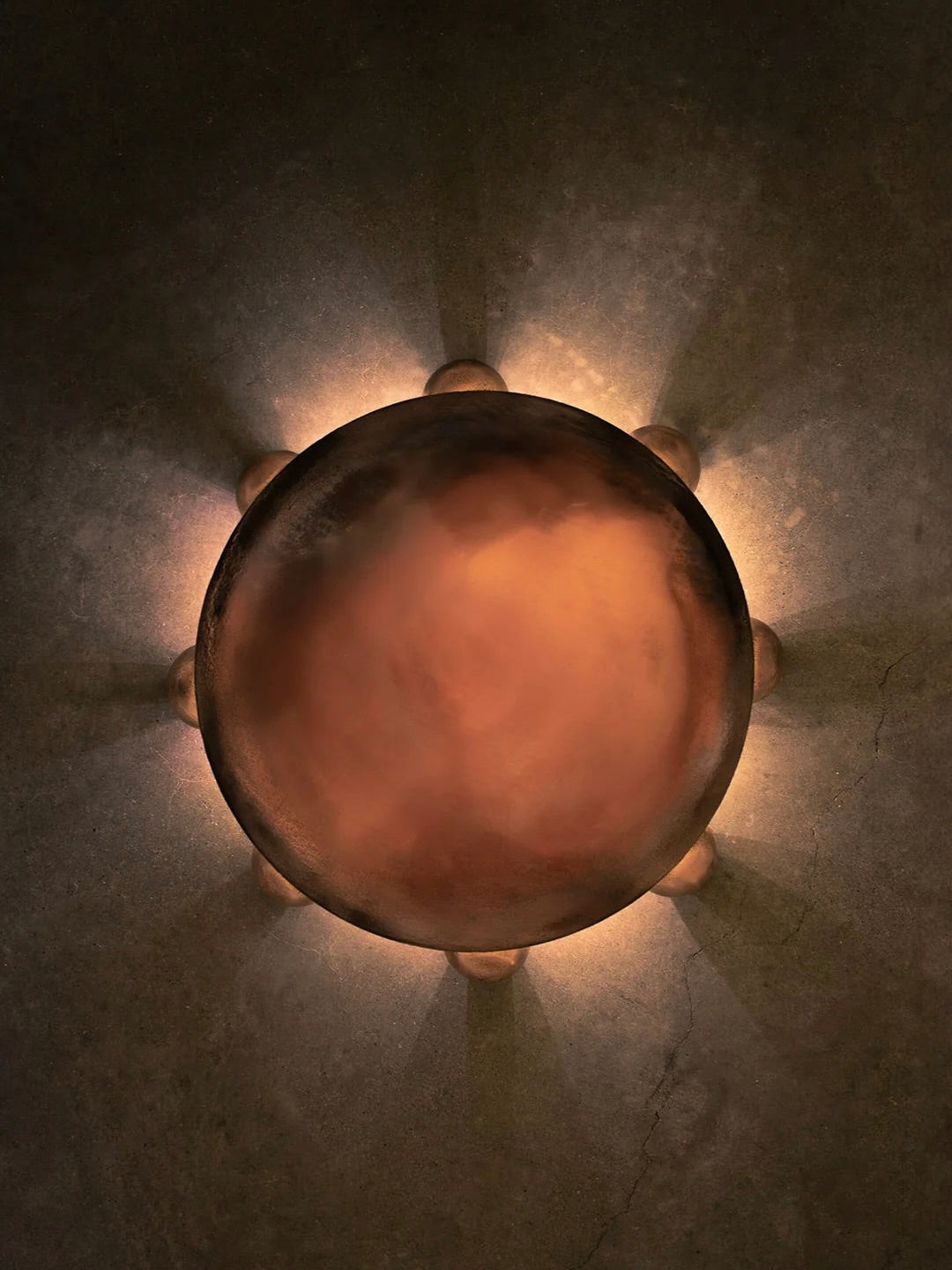 ALTER Sconce | Bronze — overhead view on textured wall