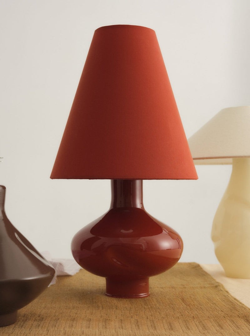 Dark red conical glass table lamp with glossy ceramic base