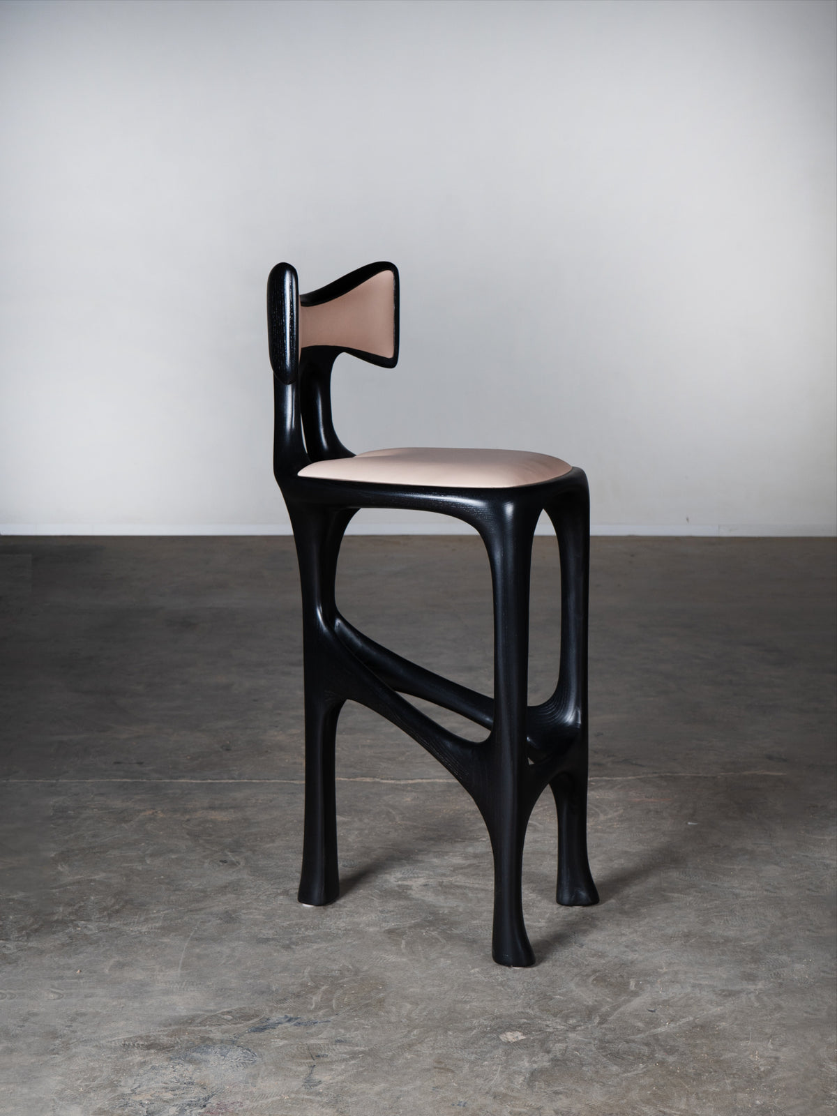 Tripa Stool in Ebony stain on Ash Wood — side view highlighting curved design