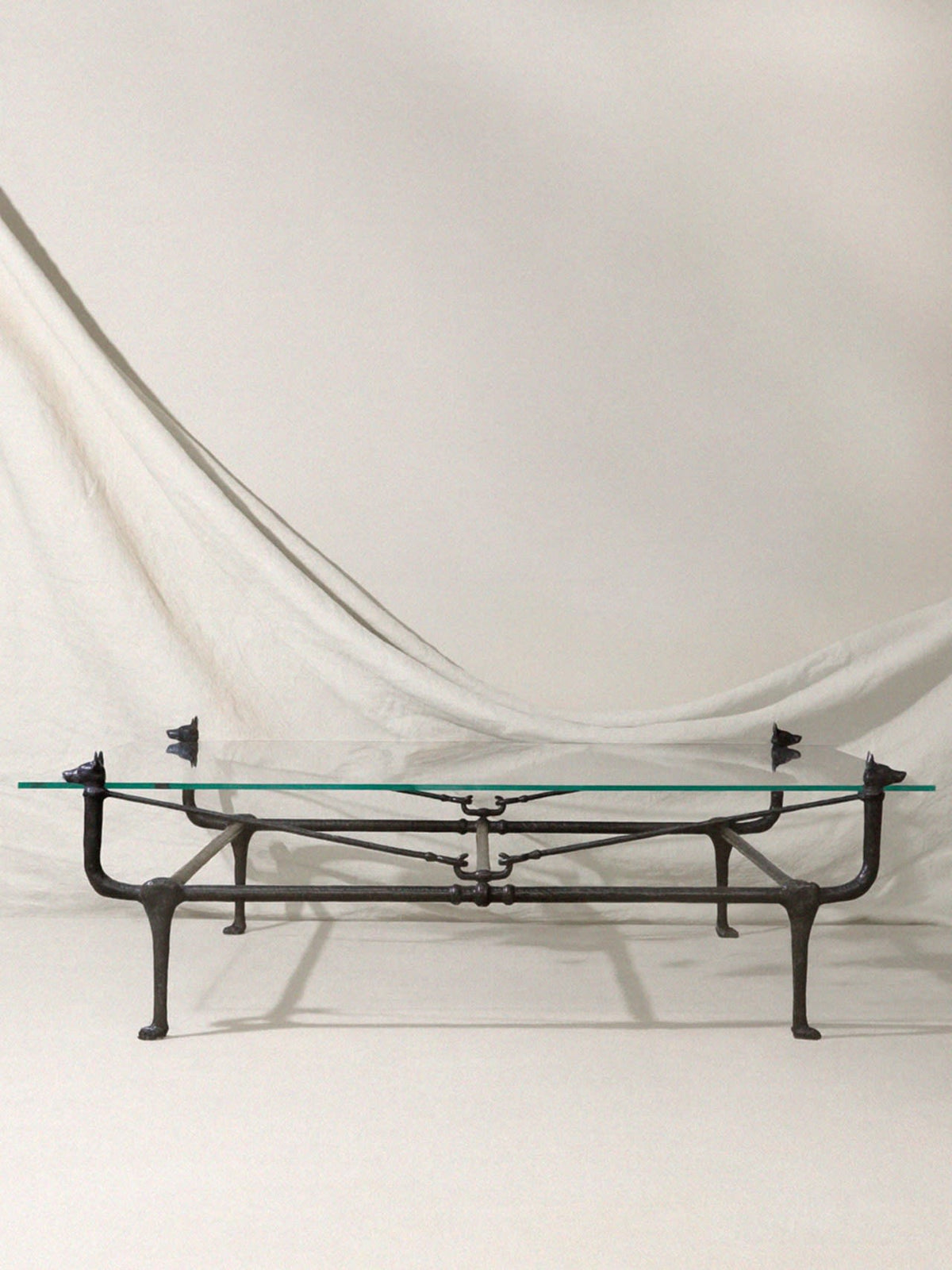 Loyal Bronze Dog Coffee Table — side view of bronze legs and glass top