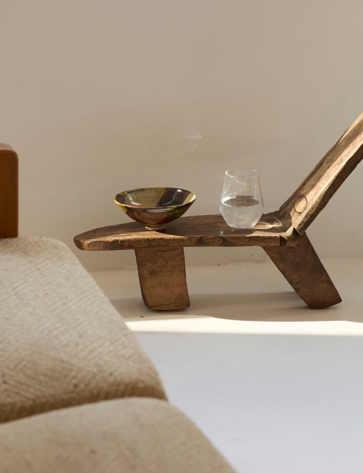 West African Monoxyle Lobi / Stargazer Chair, C. 1950 — side angle with handcrafted wooden seat and bowl