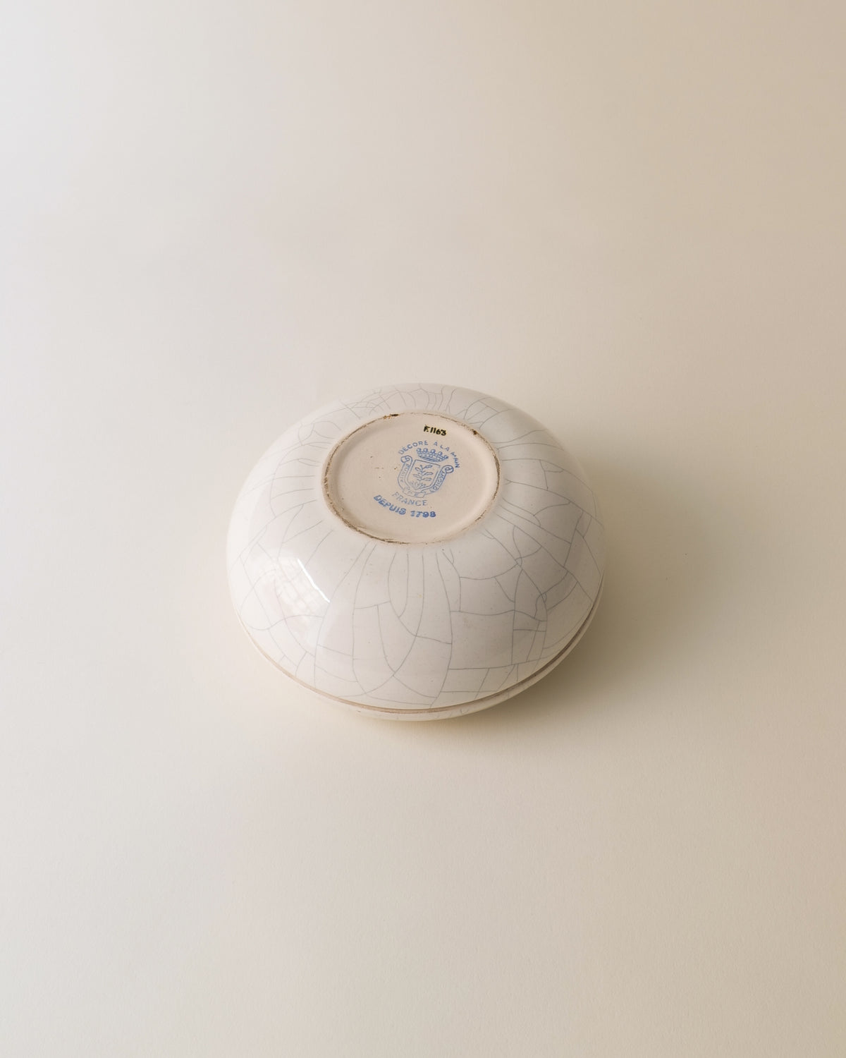 Underside of vintage Longwy ceramic jar showing maker's mark
