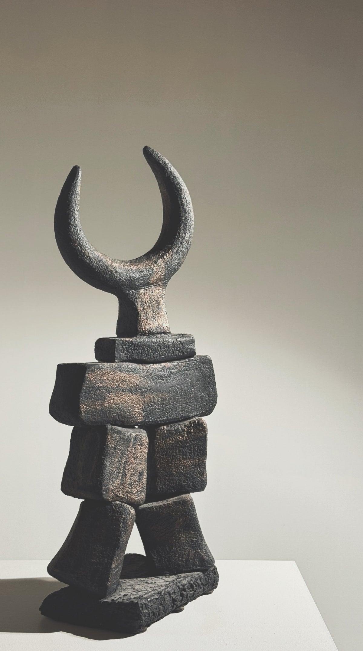 Stacked stone blocks sculpture with crescent moon top by Pouchain