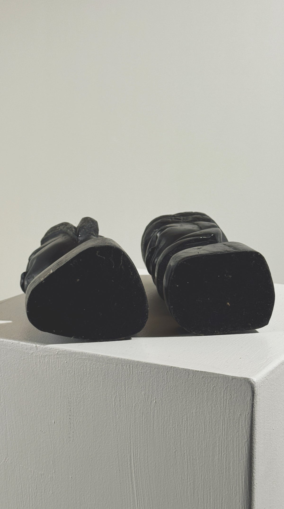 Bottom view of pair of carved ebony African busts showing dark wood bases