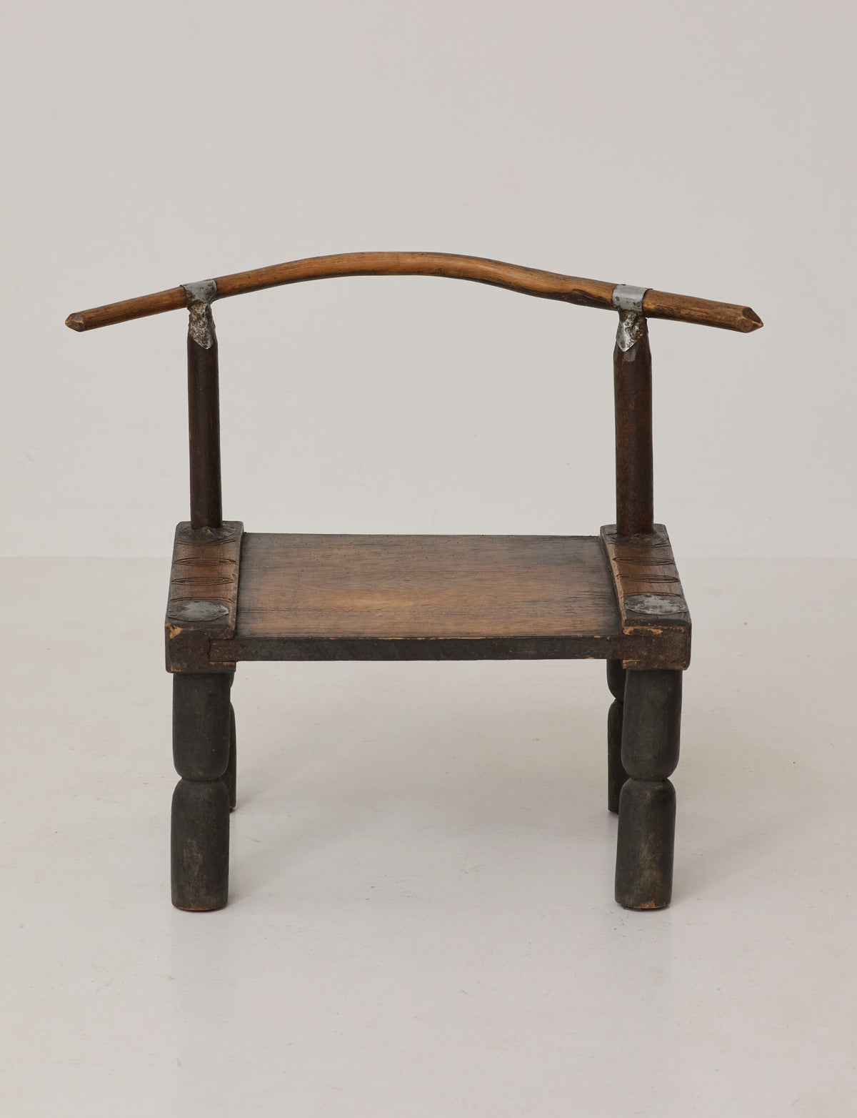 Small artisanal vintage West African chair "Baoulé" in solid wood C. 1960 — side angle