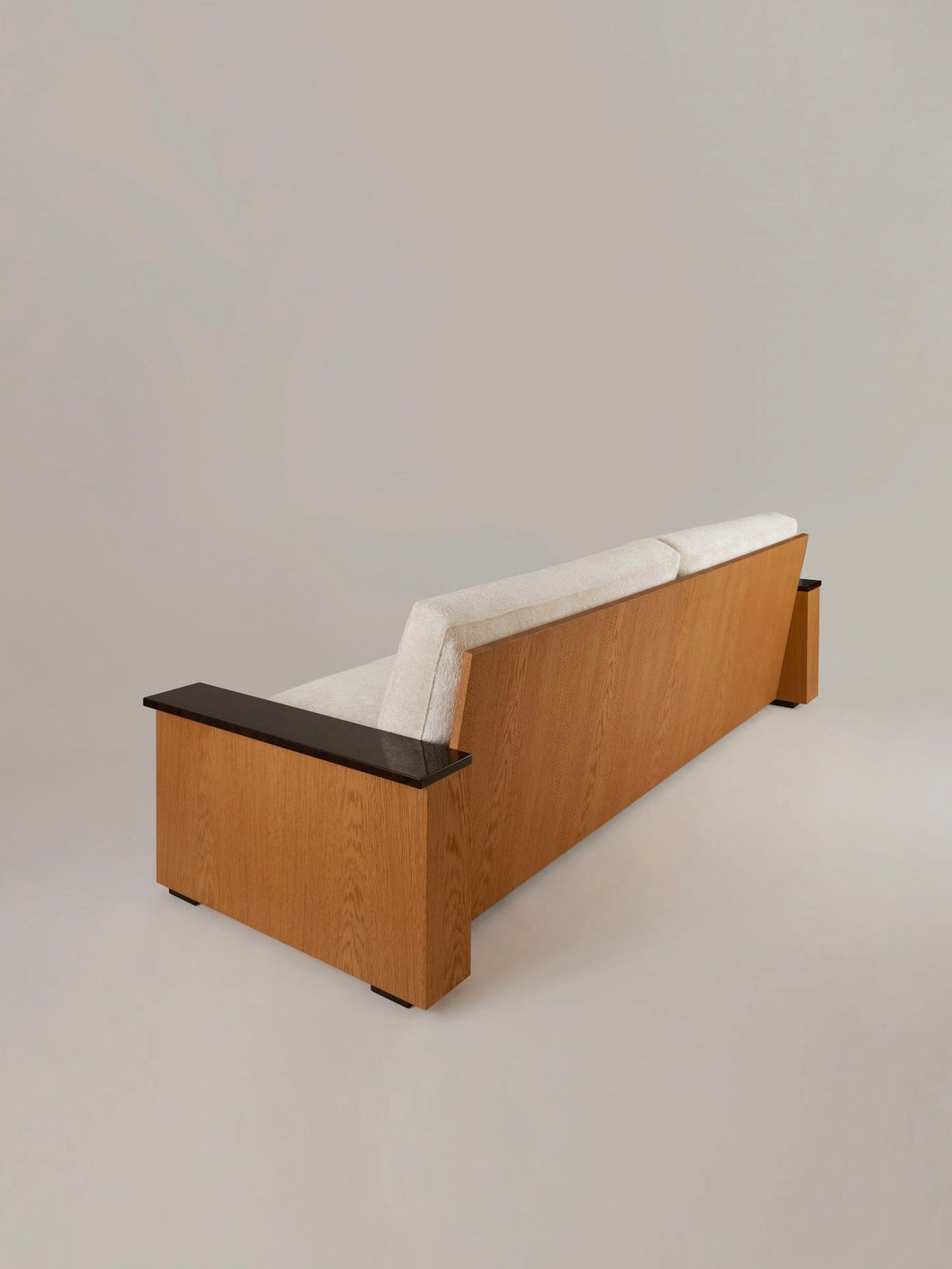 Le Colonel" Sofa (3-4 seater) — side angle showing wooden back and armrests