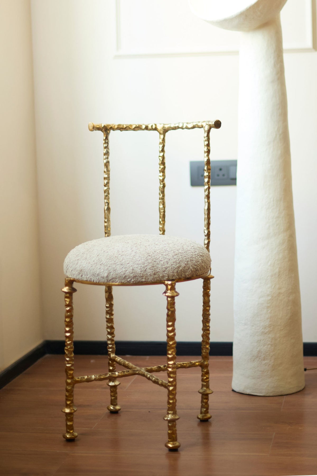 Aurelius' Cast Aluminum Chair — angled view in modern interior setting