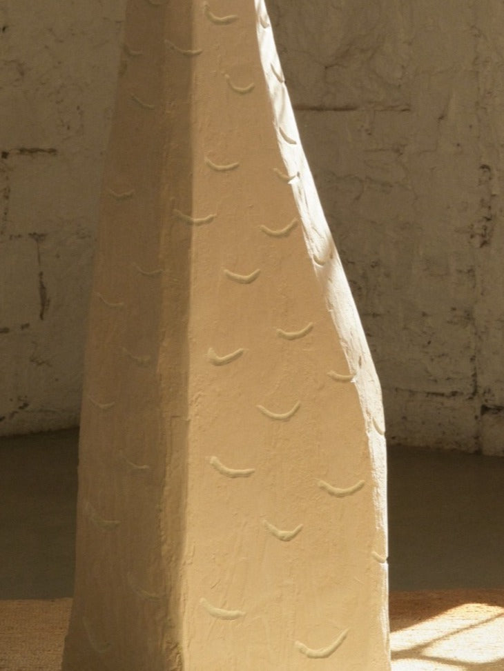 Carved stone-textured surface detail of Ruins Totem side table