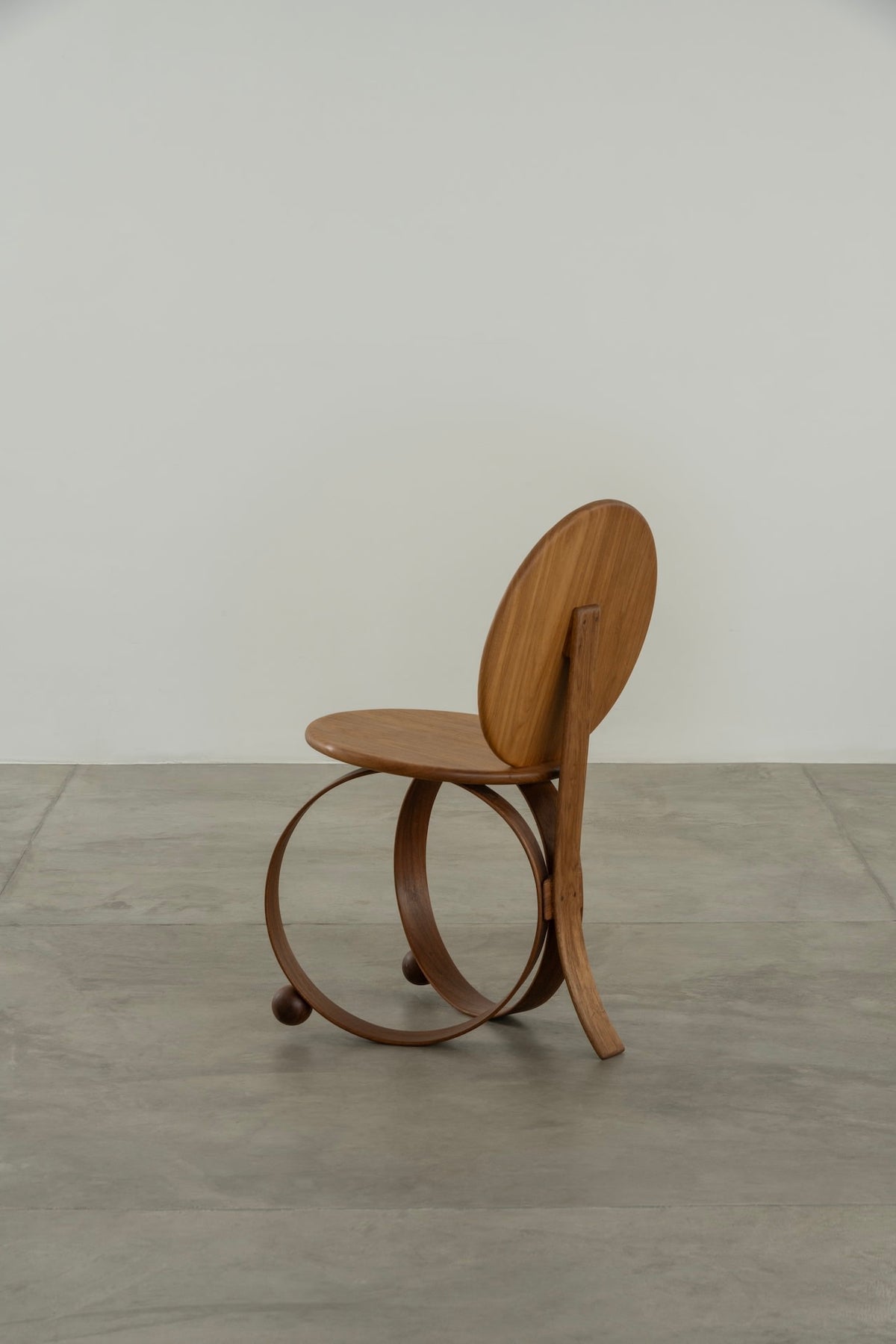 Yara' Chair — side angle showing wooden seat and circular base