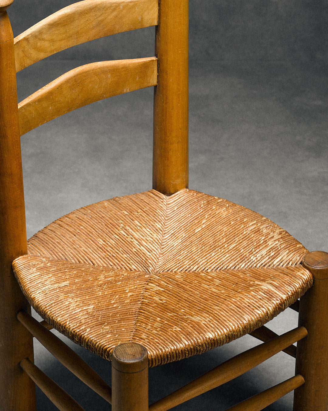 low chair with rush seat, attributed to Charles Dudouyt — alternate view