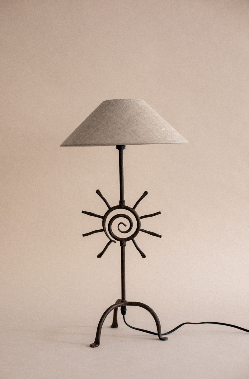 Bari table lamp with sun motif base and conical linen shade