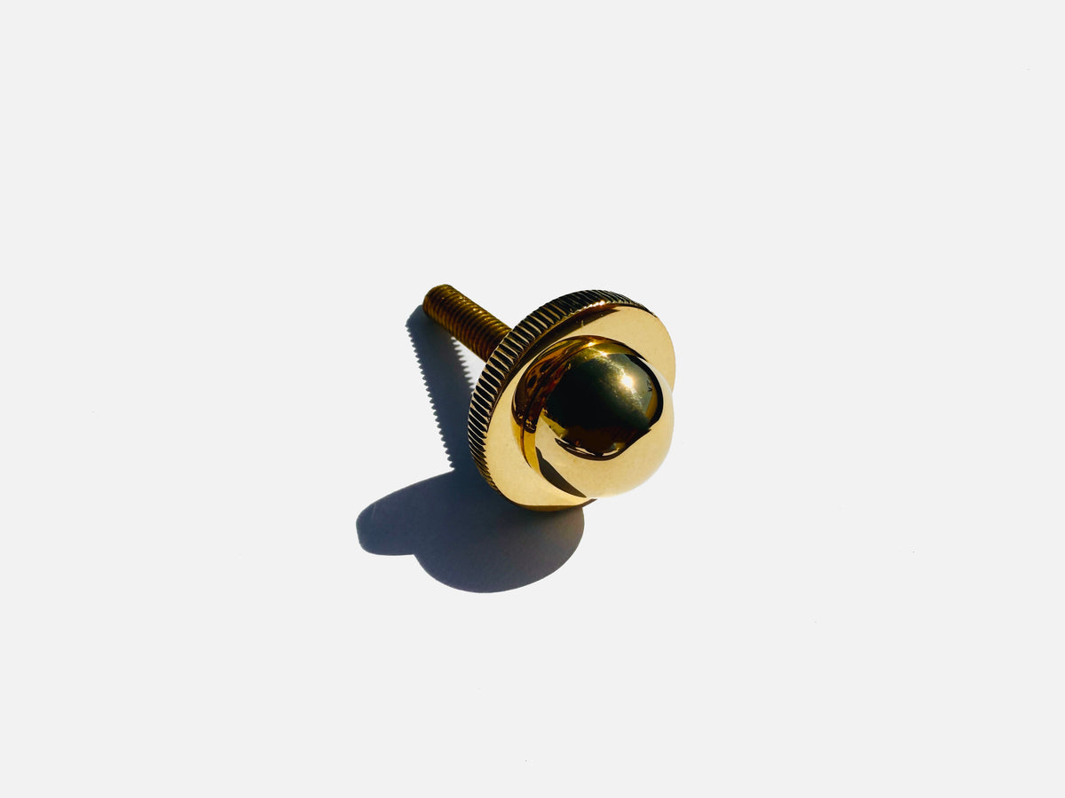 Brass pendant lamp hardware detail with threaded mounting system