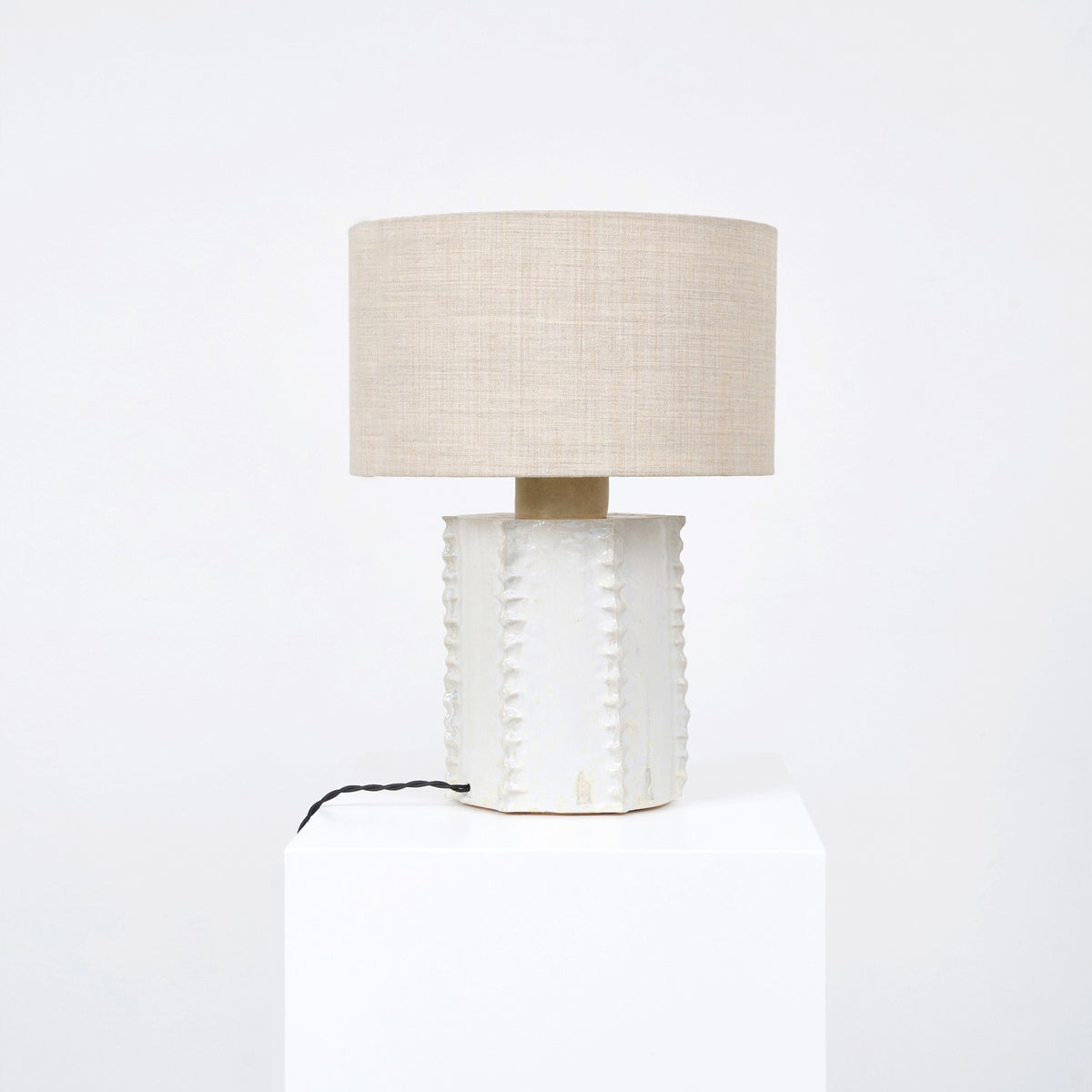 Totem Table Light — side view of textured ceramic base with linen shade