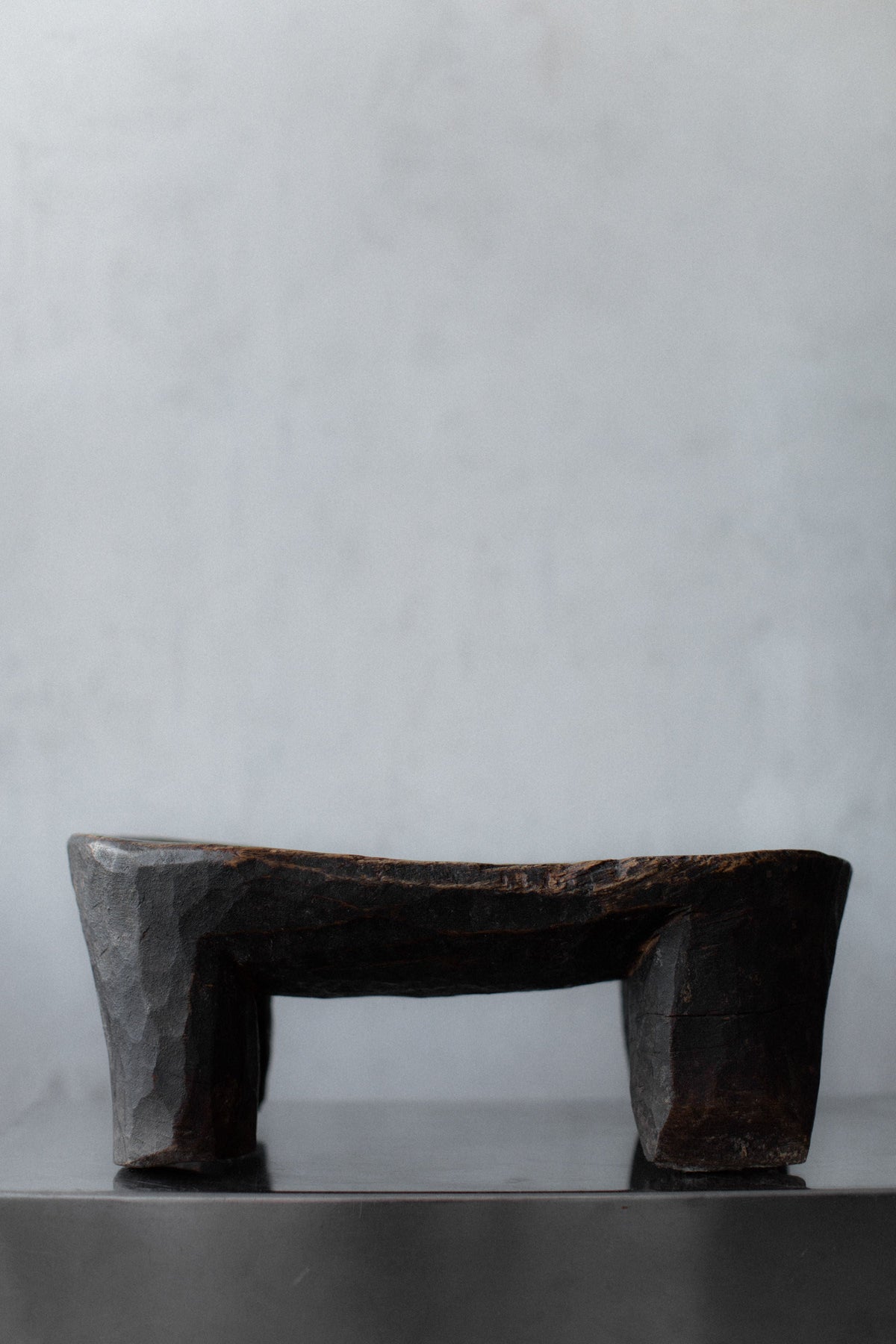 Senufo Stool — side view of handcrafted dark wood design