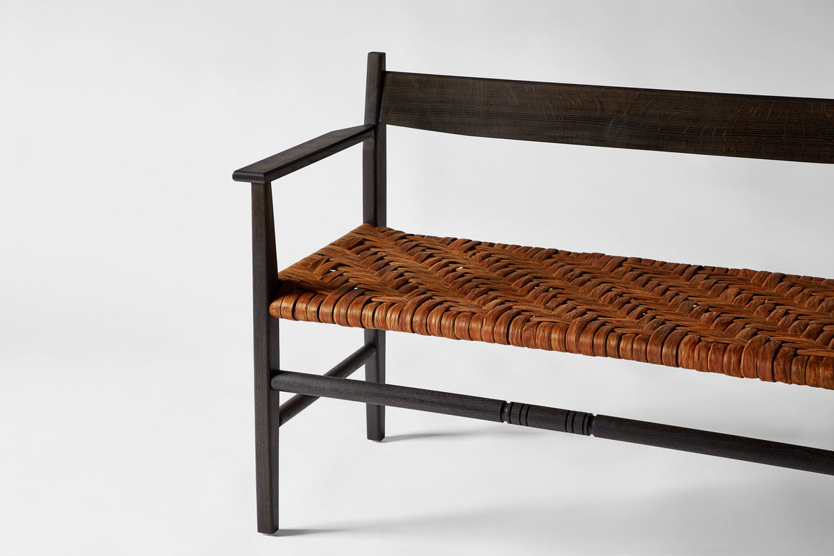 Silo Settee — side angle showing woven leather seat and wooden frame