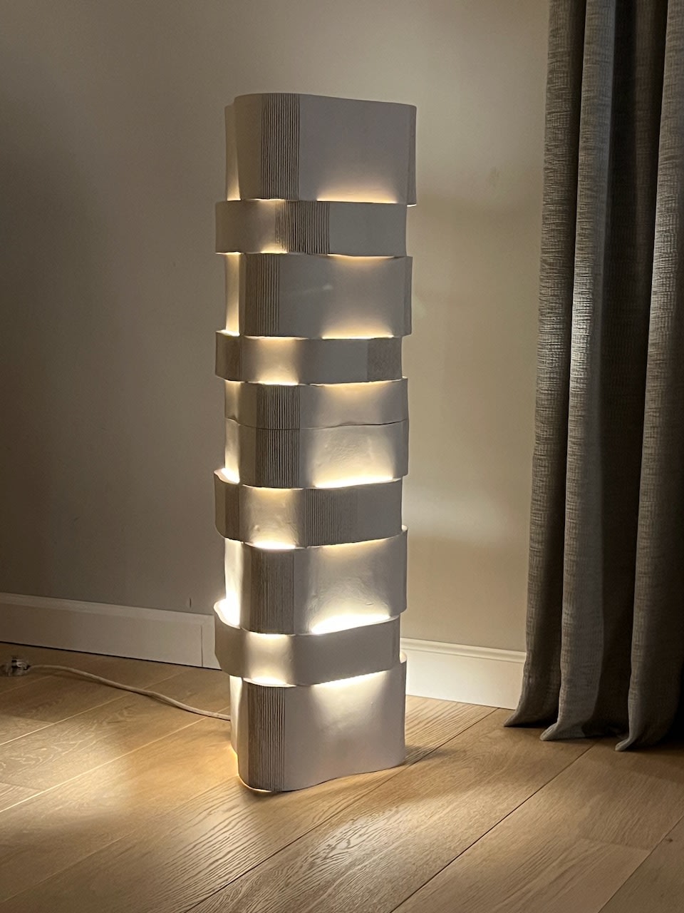 Modern ceramic floor lamp with stacked geometric segments and warm LED lighting
