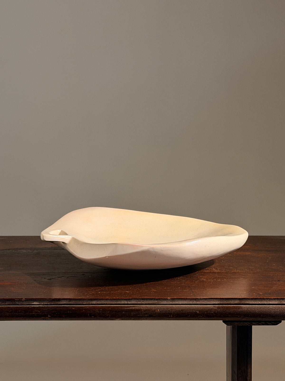 Large free-form dish in white ceramic, France, circa 1950 — side angle