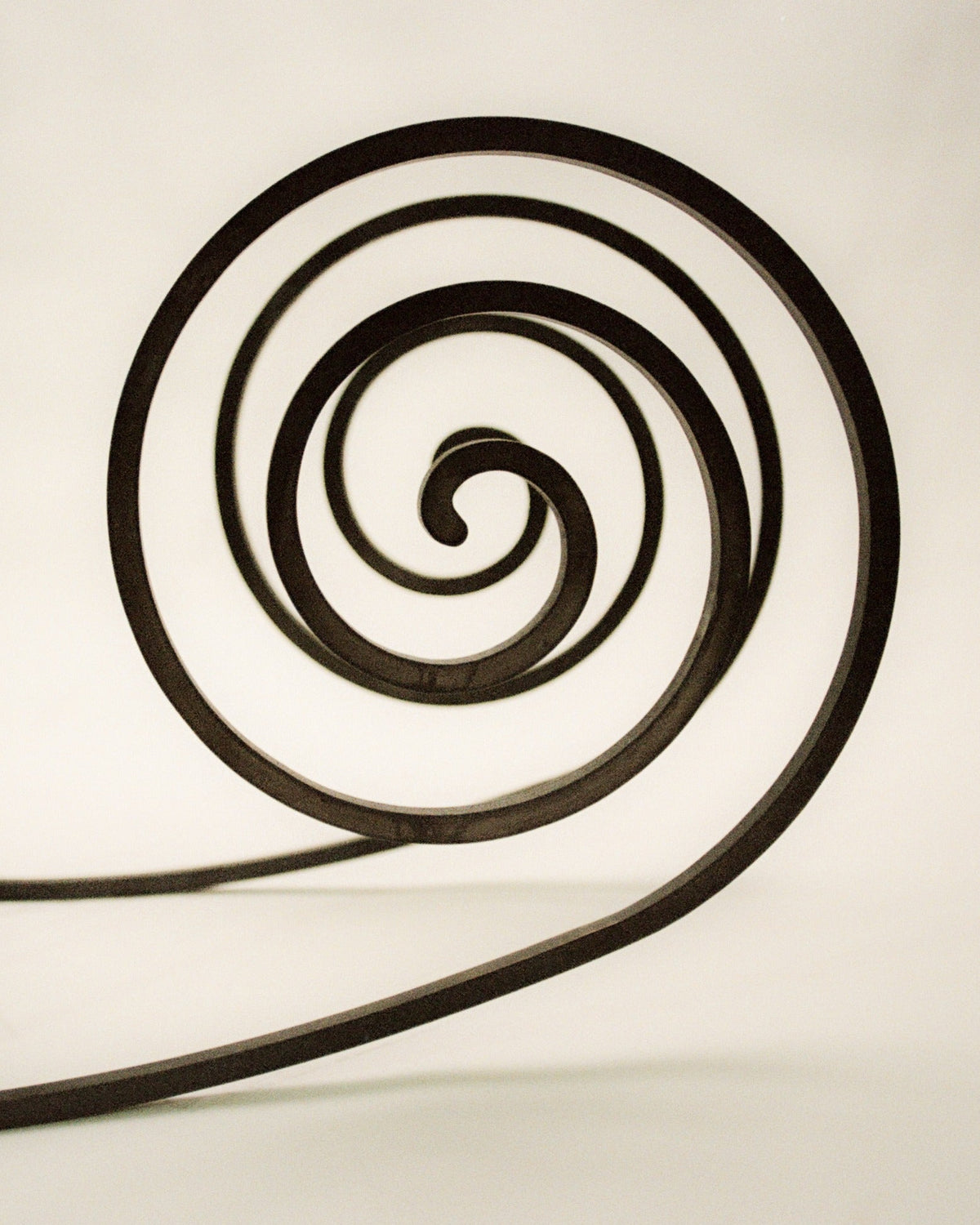 Close-up spiral detail of Rocking the Cradle chair's curved frame