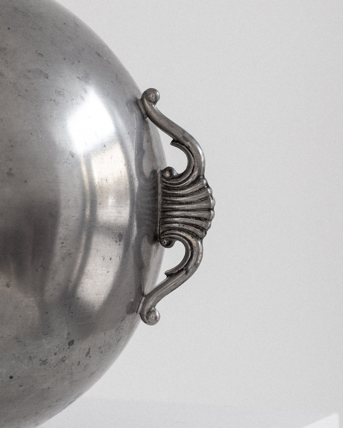 Spherical Art Deco Pewter Vase by C.G. Hallberg, 1934 — side angle highlighting ornate handle detail