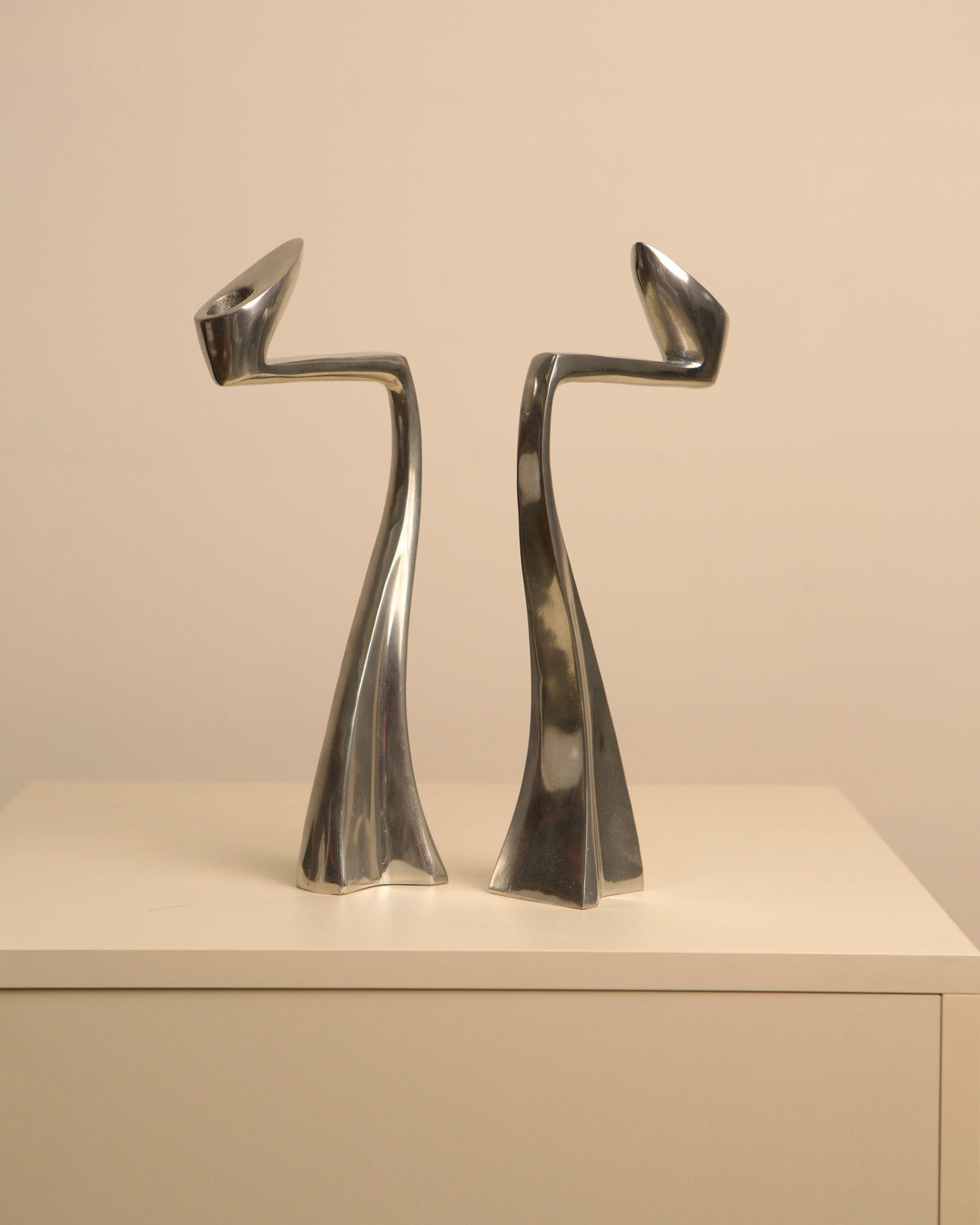 Paire de bougeoirs "Swan" par Matthew Hilton 80's — close-up of polished metal finish