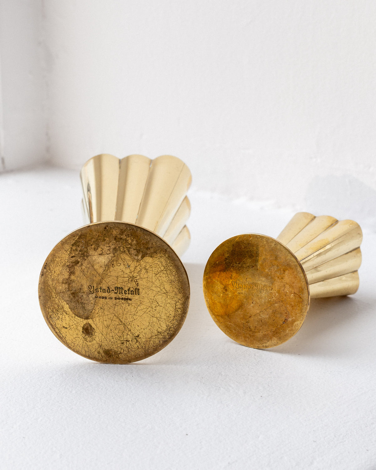 Bottom view detail of Scandinavian brass vases showing patina