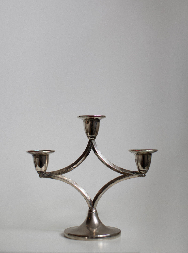 Silverplated Candleholder featuring intricate floral design and elegant curves