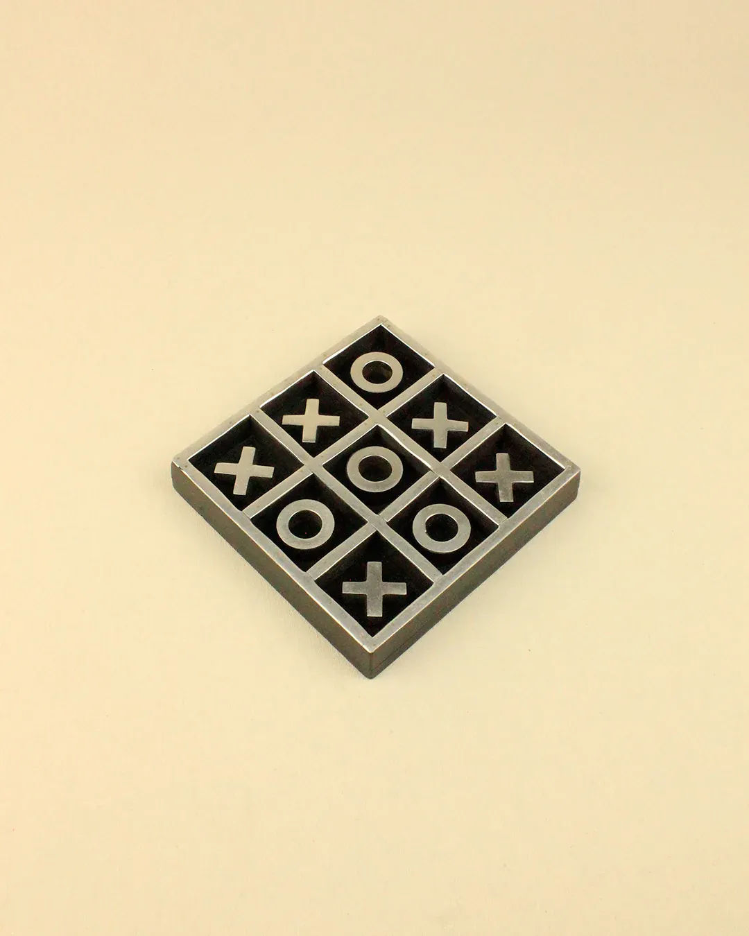 A Vintage Tic Tac Toe Game by Boga Avante Shop with xs and os in a grid pattern, displayed on a beige background. The xs have won the game with a diagonal line.
