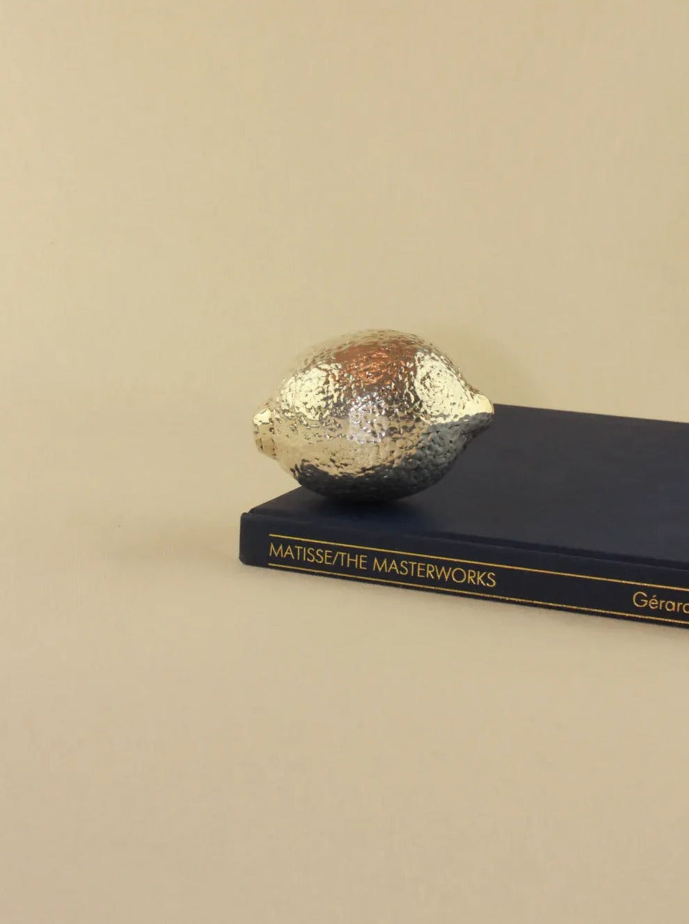  Handcrafted silver lime sculpture featuring elegant curves and shimmering surface