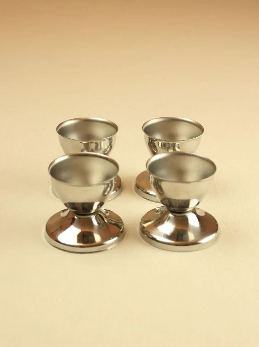 Six sleek and durable stainless steel egg cups perfect for breakfast