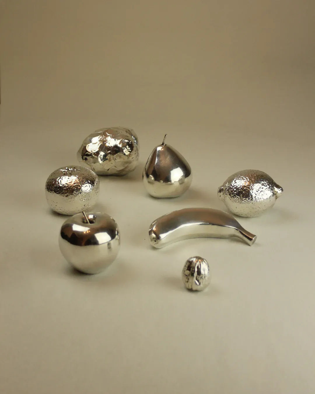 A close-up of a silver banana sculpture, featuring a polished finish and elegant design