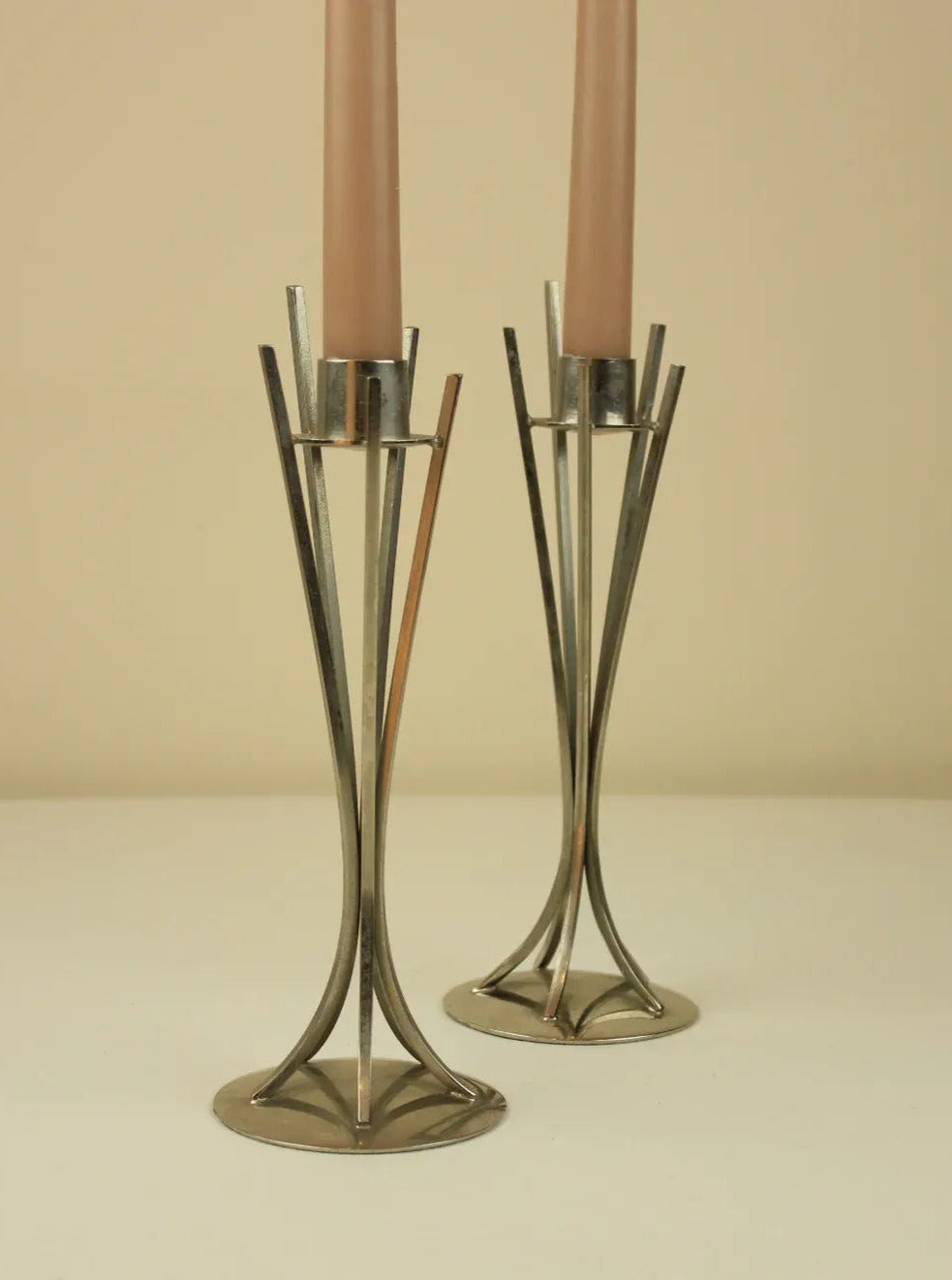 Vintage-inspired Mid-Century candleholders crafted from sleek brass and featuring geometric, minimalistic designs