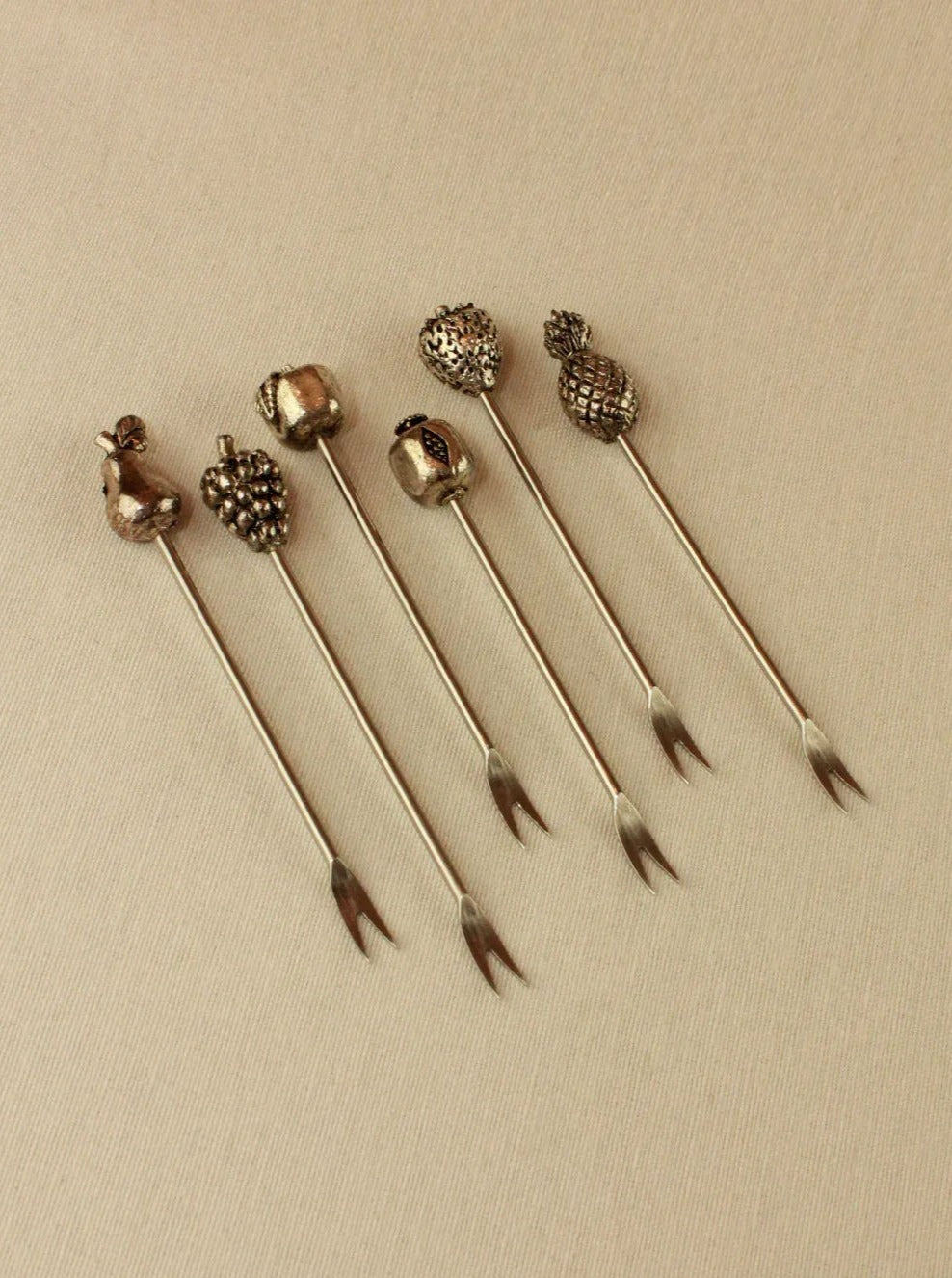  Close-up of six elegant appetizer skewers with intricate design, ideal for presenting creative and delicious finger foods at events or dinners