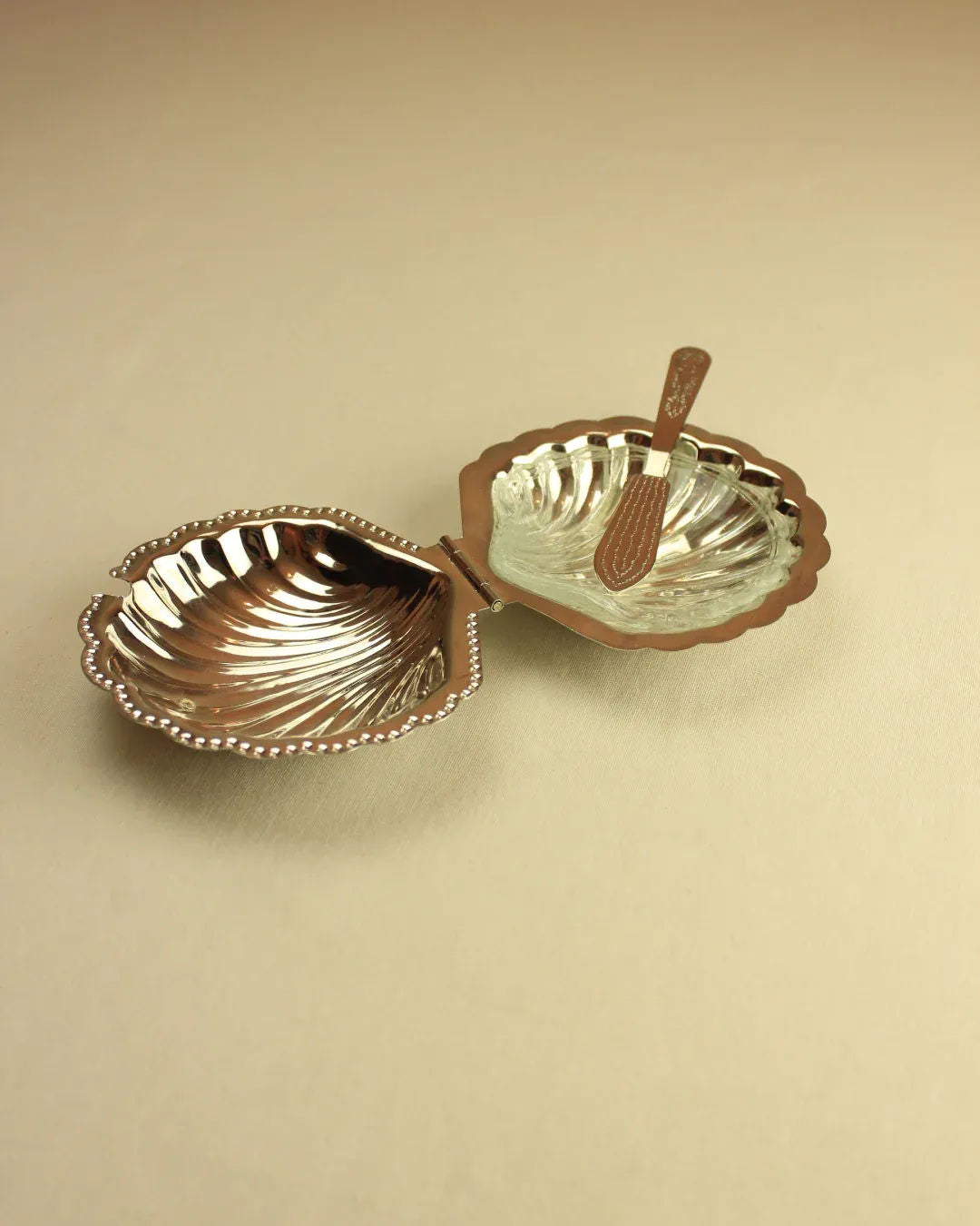 Elegant butter dish with scalloped edges and intricate detailing